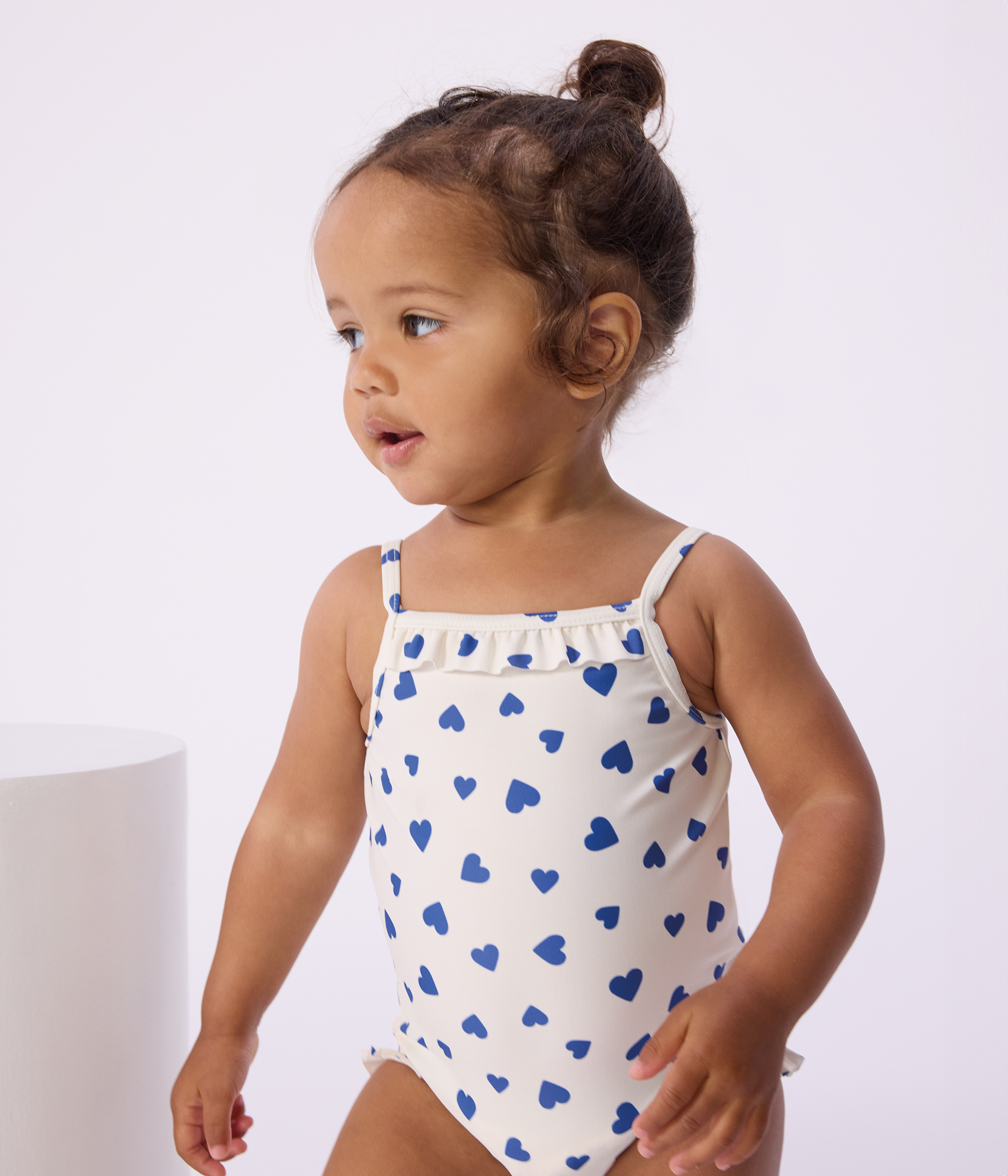 Babies' one-piece heart print ruffled swimsuit.